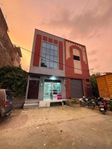 a building with a car parked in front of it at Park's Hotel Mbd in Morādābād
