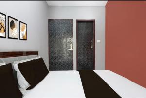 a bedroom with a bed and two glass doors at Park's Hotel Mbd in Morādābād +5 photos