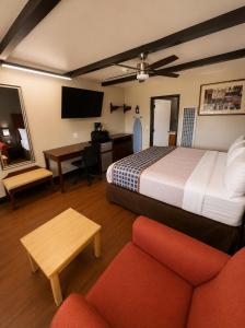 a hotel room with a bed and a desk at Buffalo Inn Vintage MOTEL in Canyon