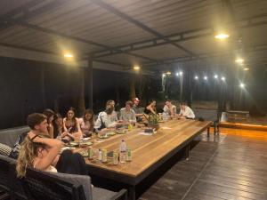a group of people sitting around a long table at Laughing Leopard Sigiriya in Sigiriya