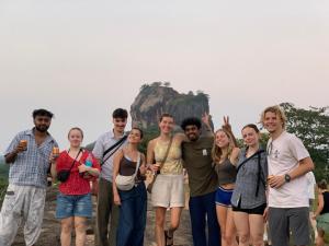 a group of people standing in front of a mountain at Laughing Leopard Sigiriya in Sigiriya +12 photos