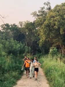 a group of people walking down a dirt road at Laughing Leopard Sigiriya in Sigiriya