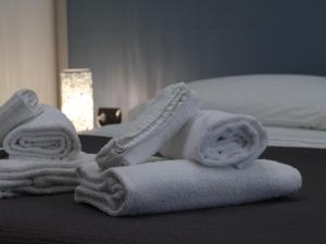 a pile of towels sitting on top of a bed at Villa Flora in Pompei +183 photos