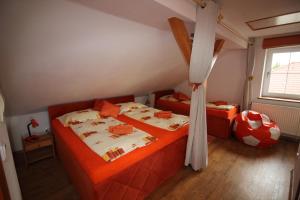 a bedroom with two beds and a soccer ball at Orange Loft Apartment in Kájov