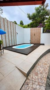 a swimming pool in the middle of a patio at Di Fronte Al Bosco in Santa Teresa