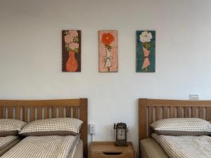 a bedroom with two beds and four pictures on the wall at Jing Zhan in Jiufen +38 photos