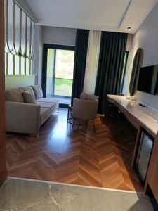 a living room with a couch and a table at Heaven resort hotel in ToÄŸanalÄ±