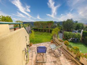 a patio with chairs and a garden with a view at Rivierarent Il Giardino Del Navigatore in Finale Ligure