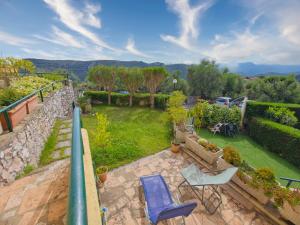 a view of a garden with chairs and a patio at Rivierarent Il Giardino Del Navigatore in Finale Ligure