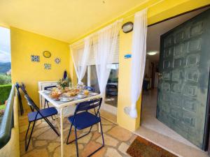 a room with a table and chairs and a door at Rivierarent Il Giardino Del Navigatore in Finale Ligure