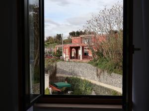 a view of a building from a window at Villa Flora in Pompei