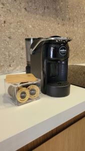 a black toaster sitting on top of a counter at Gjiri Lalzit Sunset Bliss San Pietro Premium in Draç +12 photos