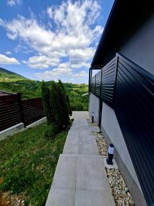 a walkway next to a building with a fence at KUĆA za odmor 128 in Plešivica