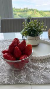 a bowl of strawberries sitting on a table at KUĆA za odmor 128 in Plešivica