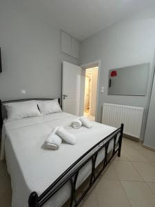 a bedroom with a bed with towels on it at Garden House in Kalamata