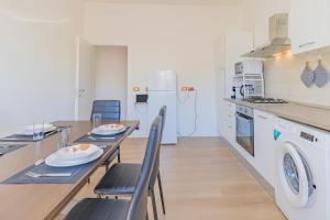 a kitchen and dining room with a table and chairs at Psalm 23 in Savona