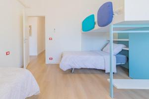 a bedroom with two beds and a bunk bed at Psalm 23 in Savona