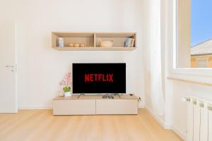 a living room with a television on a white wall at Psalm 23 in Savona