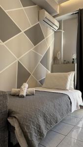 a bedroom with a large bed with a wall at GiAngels in Chania