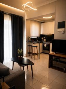 a living room with a couch and a kitchen at GiAngels in Chania