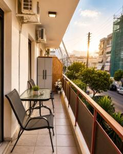 a balcony with a table and chairs and a refrigerator at GiAngels in Chania