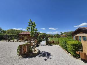 a garden with a fence and a tree in a yard at La Baita Del Bosco in Albano di Lucania