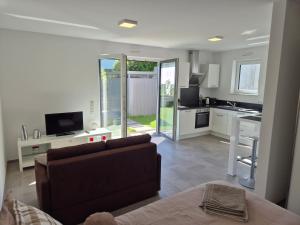 a living room with a couch and a kitchen at Studio in Wincheringen in Wincheringen