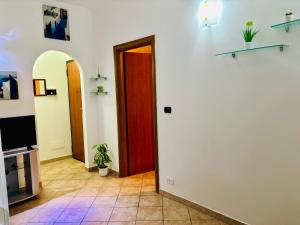a hallway with a red door and a tv at Casa Mia in Augusta +4 photos