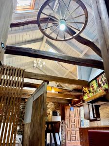 a bicycle hanging from the ceiling of a restaurant at CASA FOLIBAR-Encanto rural entre piedra y madera Valle del Silencio in Manzanedo de Valdueza