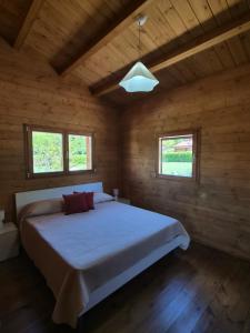 a bedroom with a large bed in a wooden room at La Baita Del Bosco in Albano di Lucania