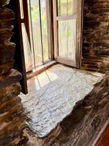 an open door in a room with a window at CASA FOLIBAR-Encanto rural entre piedra y madera Valle del Silencio in Manzanedo de Valdueza