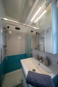 a bathroom with a sink and a shower with a mirror at Caliante in Piraino +75 photos