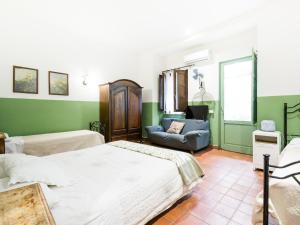 a bedroom with two beds and a couch in it at A Lumia in Noto