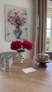a table with two vases with flowers on it at Tulipa Near Beach & Dunes with Free Parking in Noordwijkerhout