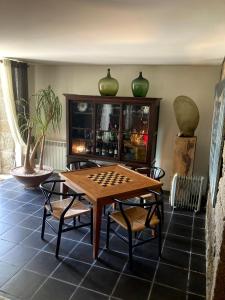 a room with a table and chairs and a cabinet at Casal do Arcebispado in Felgueiras