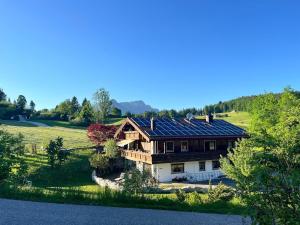 a large house with solar panels on its roof at Ferienwohnung Mariengrund in Schönau am Königssee