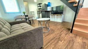 a living room with a couch and a table at Phirst Park Homes Baliwag in Baliuag +3 photos