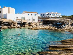 a person swimming in a body of water at Can Joan Robert des Mestre in Es Caló +4 photos