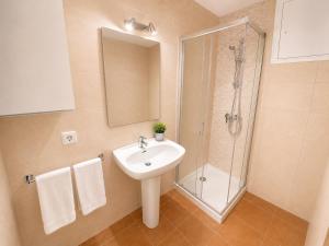 a bathroom with a sink and a shower at Can Joan Robert des Mestre in Es Caló