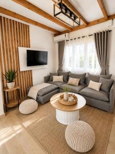 a living room with a couch and a table at Euphoria Suites and Studios in Sidari