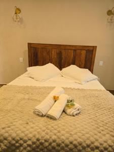 a bed with two towels on top of it at Casa De Valentina in Tiradentes +28 photos