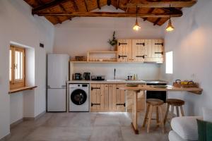 a kitchen with a white refrigerator and a table at Yiayia's House in Votsi