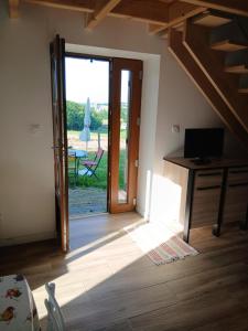 a room with a door leading to a patio at Gite de Labarraque in Monbahus