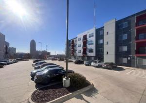 a parking lot with a row of parked cars at Olive Oasis in Des Moines
