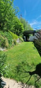 a yard with a house and a grassy field at Time Out 13 in Ohlsdorf