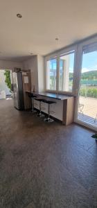 an empty office with a desk and a large window at Time Out 13 in Ohlsdorf +11 photos