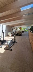 a gym with a treadmill and exercise equipment on the floor at Time Out 13 in Ohlsdorf