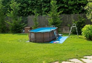 a small pool in a yard with a swing at appartamento comfort Malpensa check in h 24 posto auto privato in Casorate Sempione