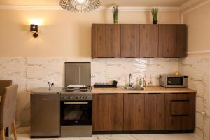 a kitchen with a stove and a microwave at Apartman Boki in Bileća