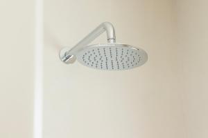 a shower head on a wall in a bathroom at the shelter - a milos project in Adamantas